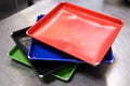 MicroSave large Teflon-coated cooking tray range in red, blue, black and green; each selected option supplies one tray