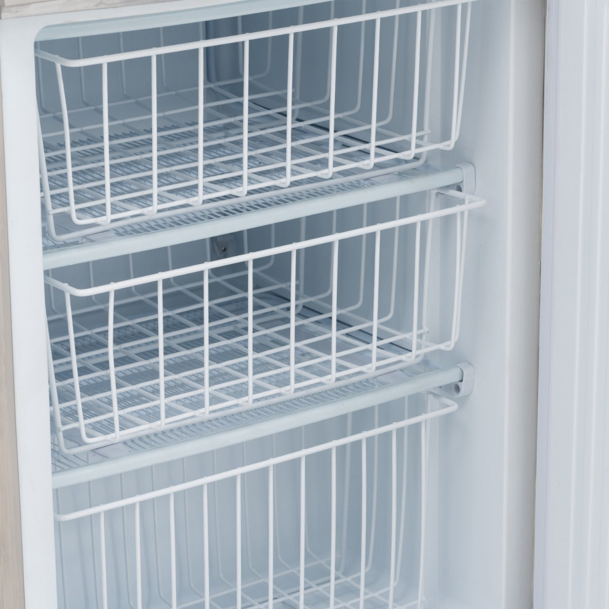 Removable wire baskets inside a freezer cabinet in the Blizzard UCFFST280 stacked arrangement